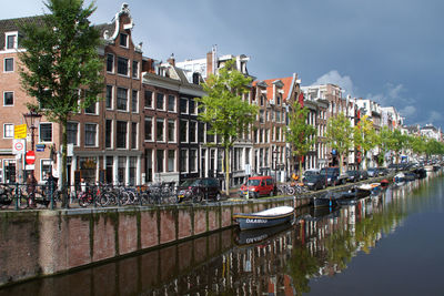 Boats moored on canal in city