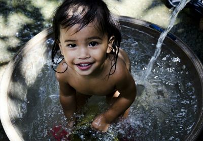 Portrait of cute girl bathing in tub