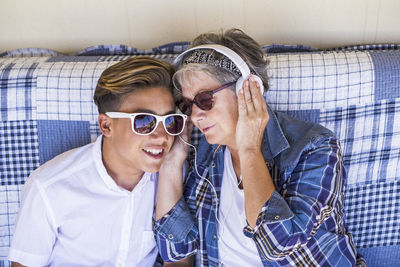 Grandmother and grandson listening music at home