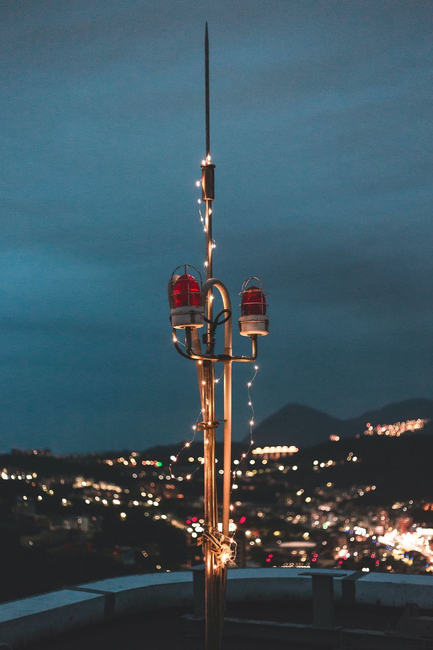 CLOSE-UP OF ILLUMINATED COMMUNICATIONS TOWER