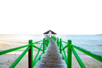 Long wooden jetty leading to sea