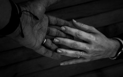 Cropped image of couple holding hands