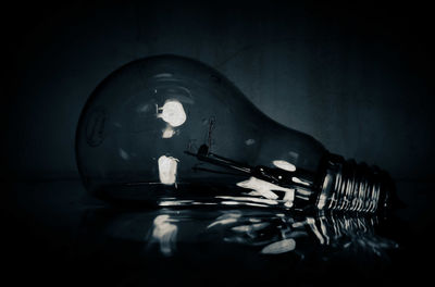 Close-up of light bulb on table