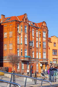 Buildings in city against clear blue sky