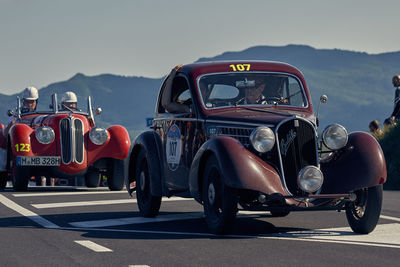 Vintage car against mountain range