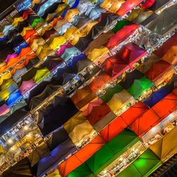 Low angle view of multi colored umbrellas hanging