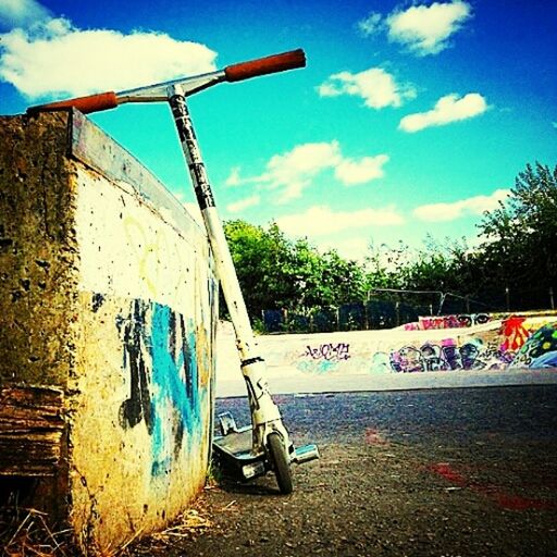 sky, tree, cloud - sky, transportation, cloud, blue, mode of transport, day, sunlight, outdoors, abandoned, beach, built structure, graffiti, cloudy, incidental people, moored, playground, sand, no people