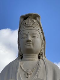 Low angle view of statue against blue sky