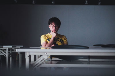 Portrait of woman sitting on table