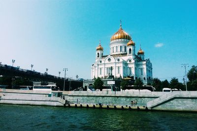 Cathedral of christ the saviour by patriarshy bridge over moskva river against sky