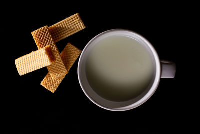 High angle view of tea cup against black background