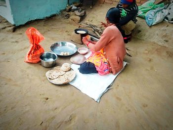 High angle view of man sitting on floor