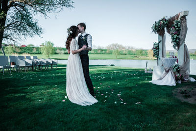 Couple dancing on lawn during wedding ceremony