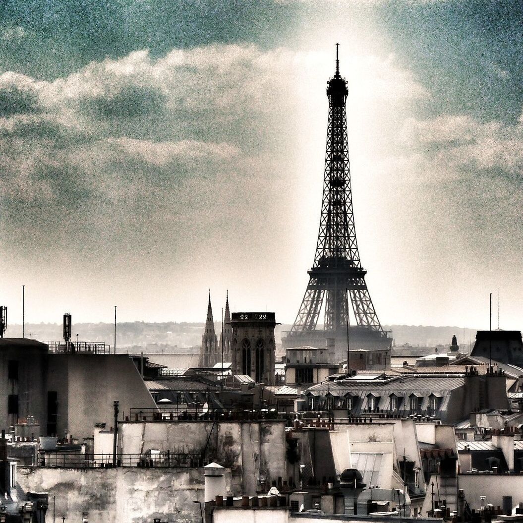 architecture, built structure, building exterior, sky, tower, tall - high, city, cloud - sky, crane - construction machinery, travel destinations, outdoors, capital cities, low angle view, metal, development, famous place, eiffel tower, no people, day, cloudy