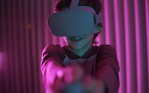 Boy wearing virtual reality simulator