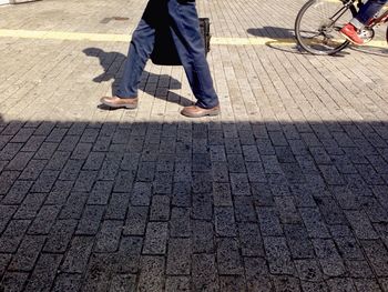 Low section of people walking on street