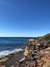 Scenic view of sea against clear blue sky