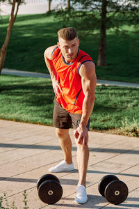 Portrait of young man exercising in gym