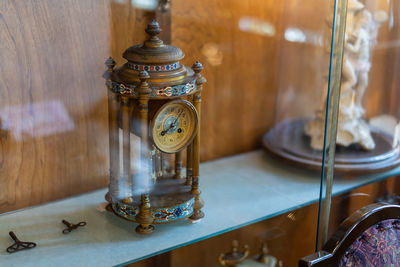 Close-up of clock on shelf