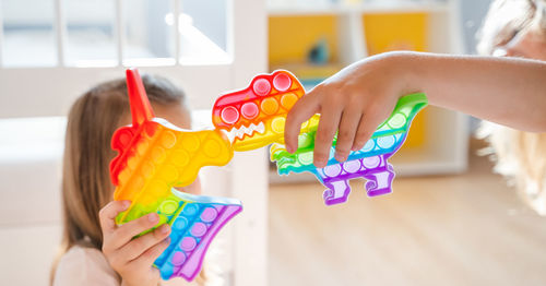 Midsection of woman playing with toy toys