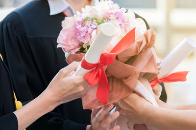 Midsection of woman holding flower bouquet