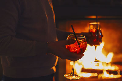 Midsection of man holding wineglass