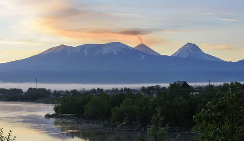 Scenic view of lake and mountains against sky