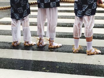 Low section of people standing on road