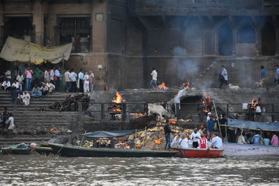 Group of people in boat against building