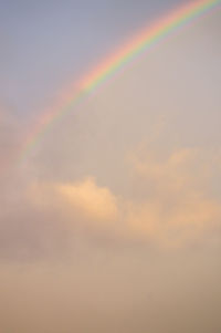 Low angle view of rainbow against sky during sunset