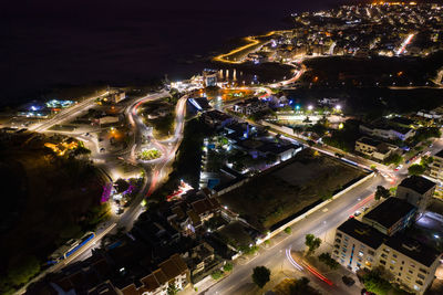 High angle view of city lit up at night