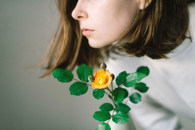 Close-up of woman with pink flower