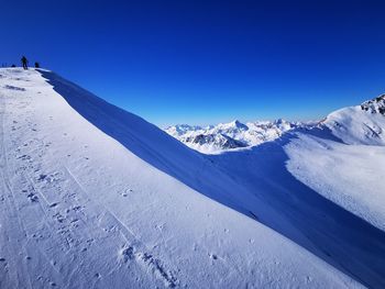 Scenic view of snowcapped mountains against clear blue sky skimo 