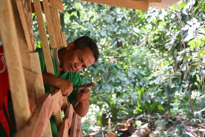 Close-up of carpenter working outdoors