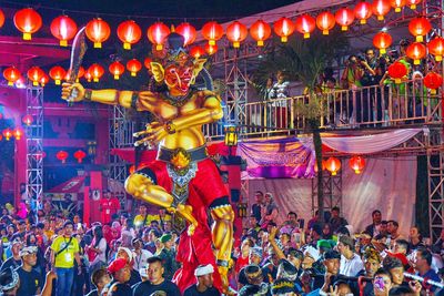 People in amusement park ride at night