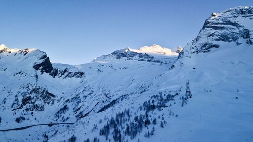 Scenic view of snowcapped mountains against clear sky