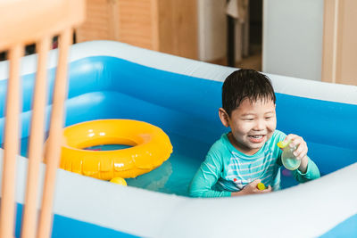 Portrait of cute boy swimming in pool