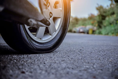 Close-up of car on road