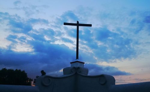 Low angle view of church against cloudy sky