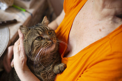 Midsection of woman with cat