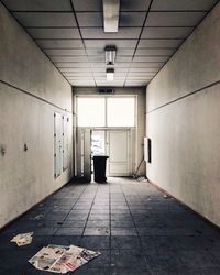 Rear view of man standing in corridor of building