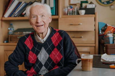 Portrait of smiling man sitting at home