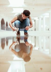 Full length of a baby boy with reflection on mirror