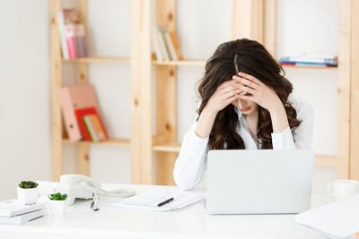 Depressed businesswoman sitting at office