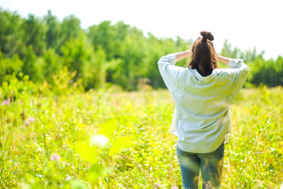 Rear view of woman on field