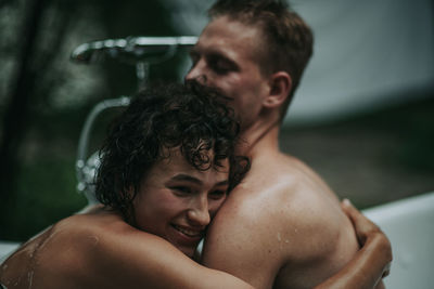 Couple in bathtub outdoors