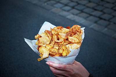 Cropped hand holding prepared potatoes