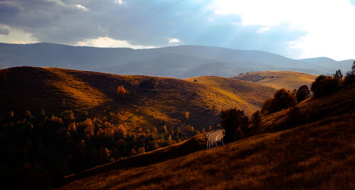 The sun at dusk through the clouds on the hills, cindrel mountains, romania