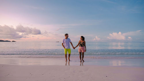 Side view of woman walking at beach