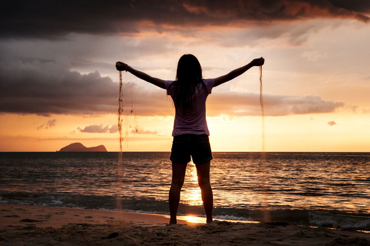 Sand sifting through hands